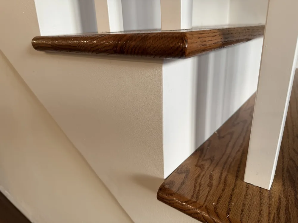 Site-built oak staircase with white risers and newel post